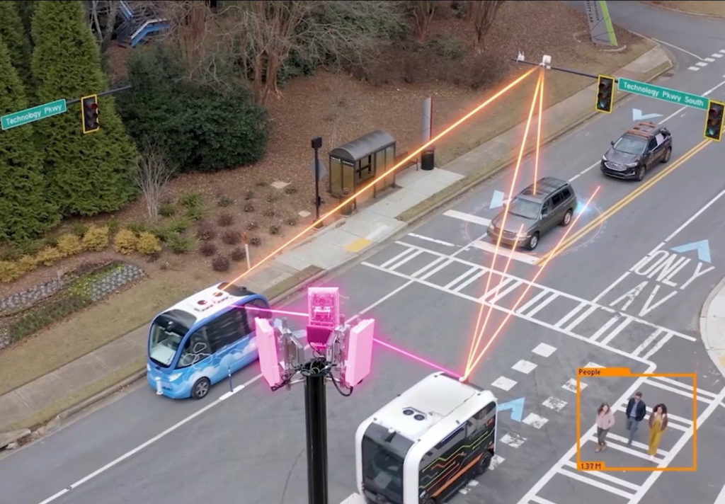 Intersection with cars, autonomous vehicles, and pedestrians.